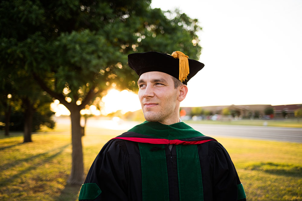 Doctorate graduate in regalia on graduation day