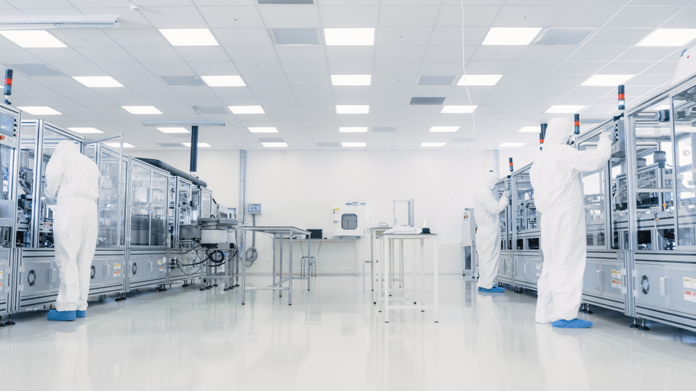 Team,Of,Research,Scientists,In,Sterile,Suits,Working,With,Computers,