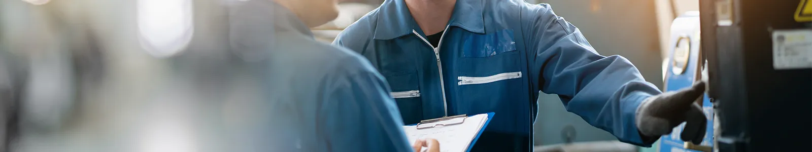 Close up of maintenance workers inspecting or servicing equipment